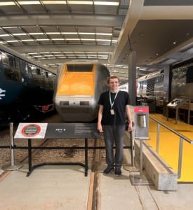 Tom stood next to a train at Shildon
