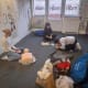Staff learning first aid at work and doing practical